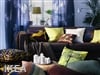 A custom drapery in bright colors enhances a living room.