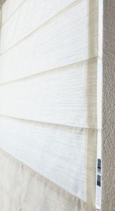 Closeup of Solid Print Roman Shade fabric in Sherlock White, showcasing fine texture and soft neutral color ideal for modern home decor.