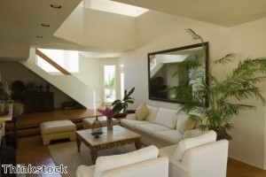 Creating comfortable conversation areas in a living room warms up the space.