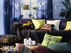 A custom drapery in bright colors enhances a living room.