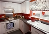 A wood valance can tie in window treatments with nearby cabinetry.