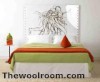An art work or wall hanging can replace a traditional headboard.r