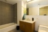 Create a simple, elegant bathroom with faux wood blinds